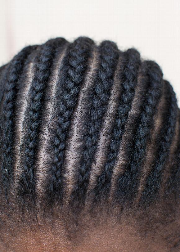Close up of man's head with cornrows