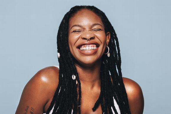 Smiling woman with dreadlocks